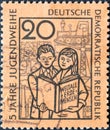 Boy and girl with the book Ã¢â¬ÅWeltall, Erde, MenschÃ¢â¬Â, symbolic